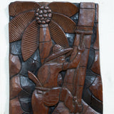 Wood Carved Artwork of Man Climbing Tree