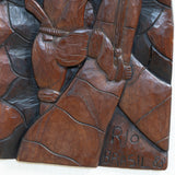 Wood Carved Artwork of Man Climbing Tree