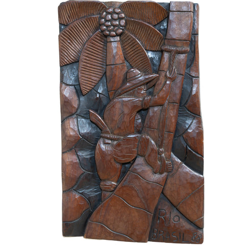 Wood Carved Artwork of Man Climbing Tree